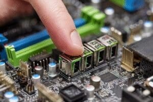 A finger counting USB ports on a motherboard answering how many USB ports does my motherboard have