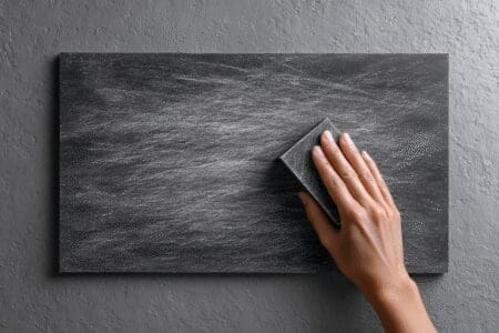 A hand erasing a slate a metaphor for how to reset a graphics card